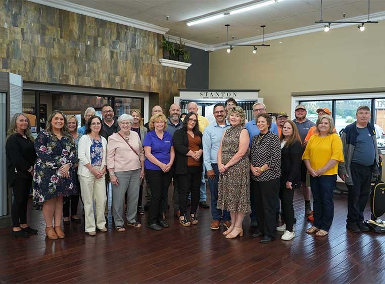 Company staff posing for a photo in the showroom
